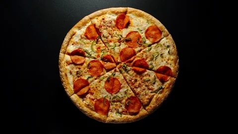 TIME-LAPSE: Circle Of Big Pizza Is Fast Rotating On A Black Surface Видео 114211288