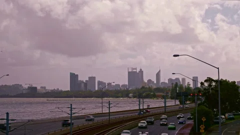 Time lapse of city - storm clouds sweep above. Traffic and railway in foreground Stock-Footage 282770667
