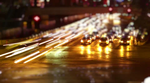 Time lapse of city traffic at night - tilt shift Stock Footage