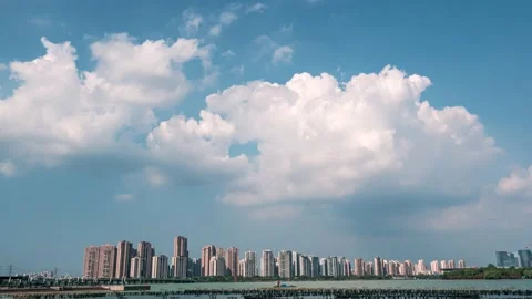 Time lapse cityscape at daytime blue sky, clouds pass over downtown multistorey Video stock 148478233