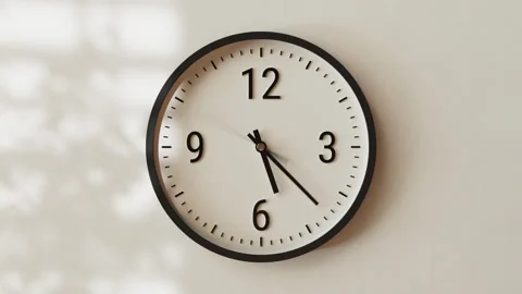 Time-lapse classic wall clock, textured warm light beige concrete background Stock Footage 299659732