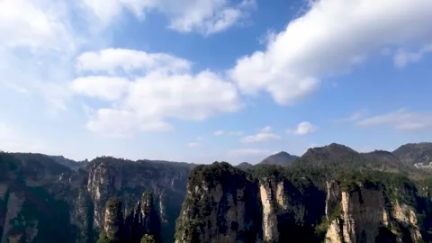 Time Lapse of Clear Sky White Clouds Peculiar Peak Cliff Stock Footage 337930433