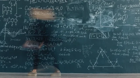 Time lapse of clever lady professor writing formulas in classroom on board Stock Footage