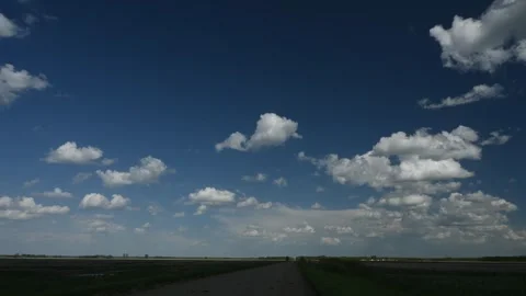 Time lapse clip looking down a gravel country road as white clouds driftimg Stock Footage 277073165