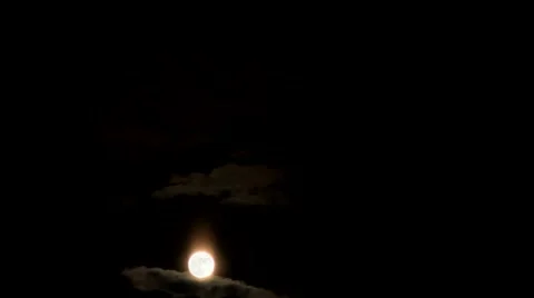 Time lapse clip of smooth moving moon behind clouds and trees Stock Footage 45114621