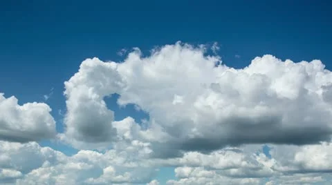 Time lapse clip of white fluffy clouds over blue sky Stock Footage 12520099