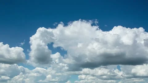 Time lapse clip of white fluffy clouds over blue sky Stock Footage 12520104