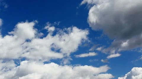 Time lapse clip of white fluffy clouds over blue sky Stock Footage 21256328