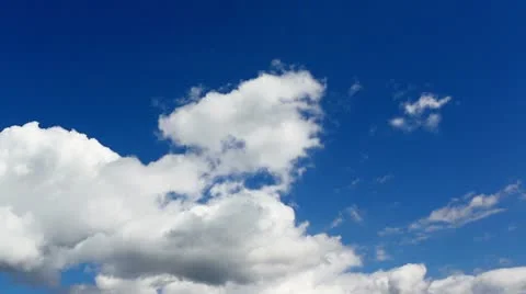 Time lapse clip of white fluffy clouds over blue sky Stock Footage 21256374