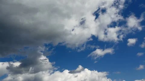 Time lapse clip of white fluffy clouds over blue sky Stock Footage 21256375