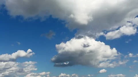 Time lapse clip of white fluffy clouds over blue sky Stock Footage 21256422