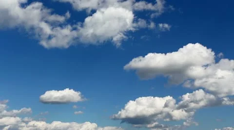Time lapse clip of white fluffy clouds over blue sky Stock Footage 21256427
