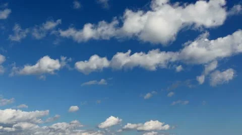 Time lapse clip of white fluffy clouds over blue sky Stock Footage 21256438