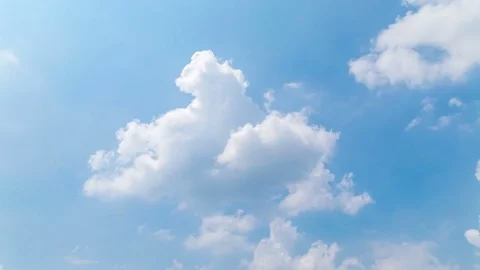 Time lapse clip of white fluffy clouds over blue sky 스톡 동영상 74396547