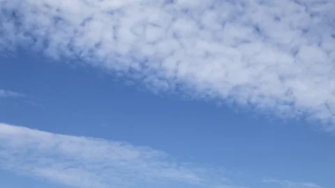 Time lapse clip of white fluffy clouds over blue sky Stock Footage 76727554