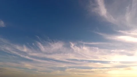 Time lapse clip of white fluffy clouds over blue sky at the sunset Stock Footage 87495370