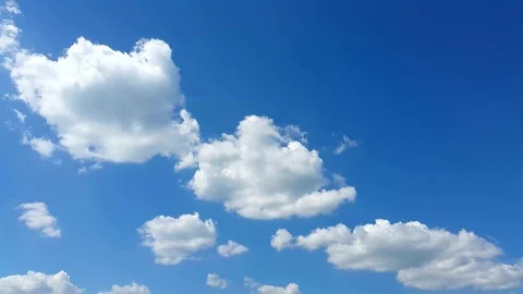 Time lapse clip of white fluffy clouds over blue sky Stock Footage