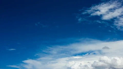 Time lapse clip of white fluffy clouds over blue sky Stock Footage 93856210