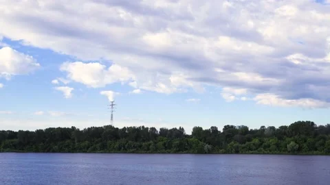 Time lapse clip of white fluffy clouds over blue sky over river. Puffy fluffy 動画素材 140840157