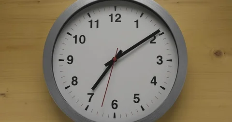 Time-lapse clock with black arrows shows time 07.00 speed up and slow to 08.00 Stock Footage 121154110