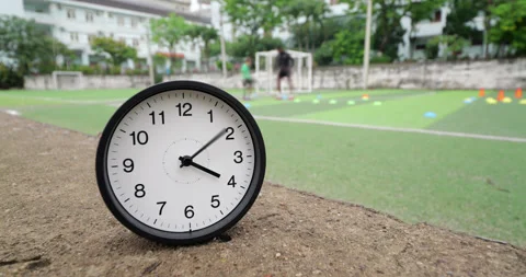 Time-lapse of clock with fast spinning hands at soccer training field Stock Footage 345716511