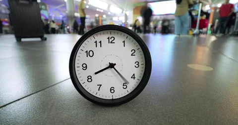 Time-lapse of clock with surreal fast spinning hands in airport hall Stock Footage 345716374