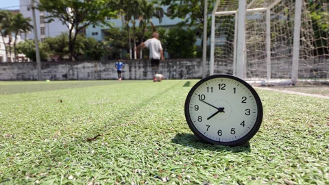 Time lapse clock ticking fast by soccer goal with player kicking drills Stock Footage 345644950