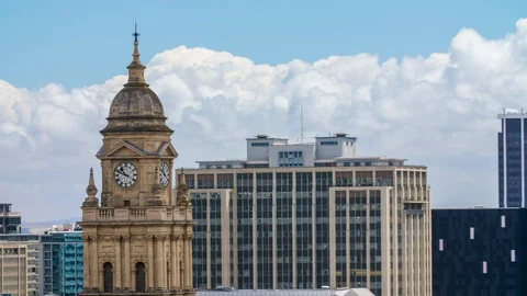 Time lapse of clock tower in urban city with rapidly moving cloud patterns Stock Footage 101083195