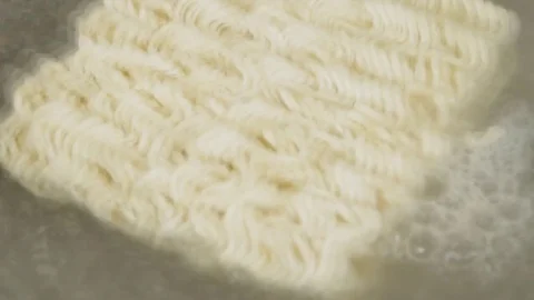 Time lapse of Close up boiling water with noodles in the pan Video stock 73828085