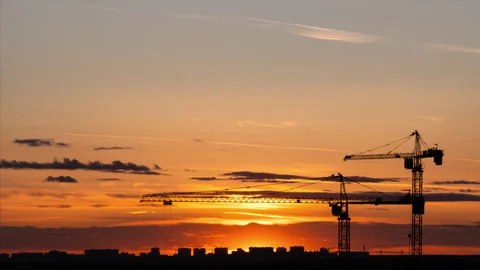Time lapse. Close-up video of construction site with silhouettes of two cranes 스톡 동영상 310207552