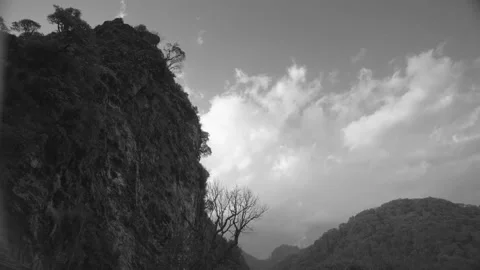 Time Lapse The Cloud moving by wind against Huge Mountain with Tree Branch Stock Footage 154019689