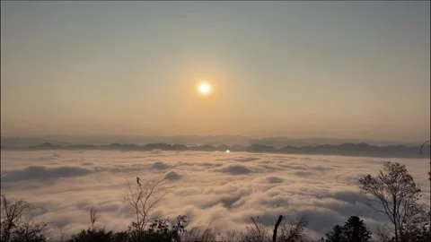 Time-lapse of Cloud Waterfall Flowing Over Mountain Ridge at Sunrise. Stock Footage 327765088