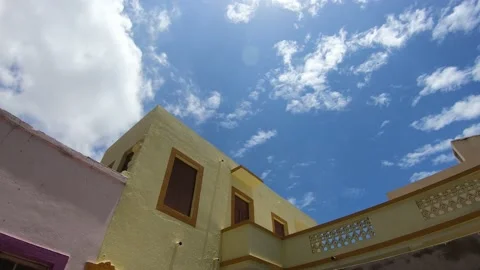 Time lapse of clouds above the building Stock Footage 136952590