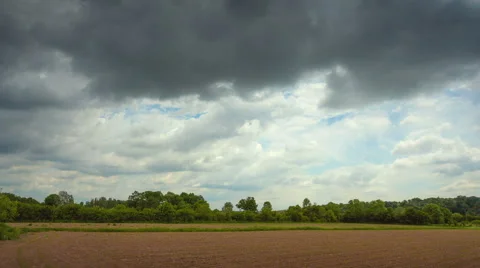 Time lapse of clouds above the cultivated land HD 24 fps Stock Footage 49966777