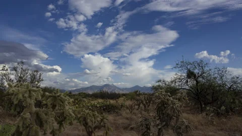 Time lapse of clouds above a desert landscape with a distant mountain range Stock Footage 198511728