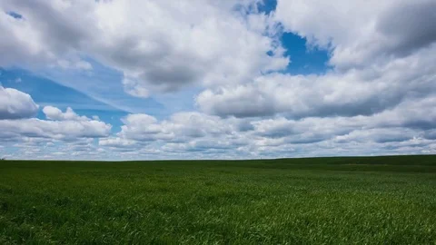 Time lapse of clouds above endless green farmland Stock Footage 79722122