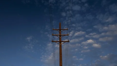 Time lapse of clouds above a power line pole in morning light Stock Footage 130065335