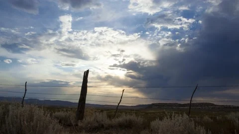 Time lapse of clouds above a ranch fence and the Utah landscape Stock-Footage 133916310