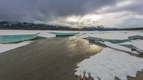 Time lapse of clouds above thick chunks of ice with open water Stock Footage 85214153