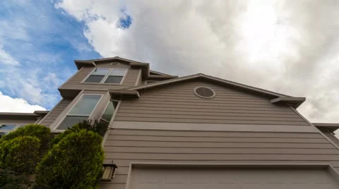 Time lapse of clouds and blue sky over luxury suburban residential home 4k uhd Stock Footage 62494395