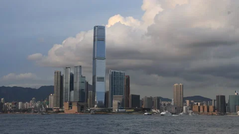 Time lapse of clouds and boats moving around High rise buildings in tsim sha  Stock Footage 154627955