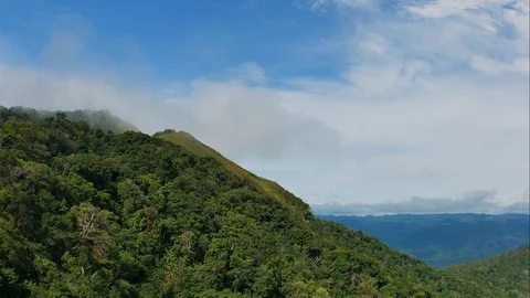 Time Lapse of Clouds and fog flow through the mountains on a beautiful blue sky. Stock Footage 109557875