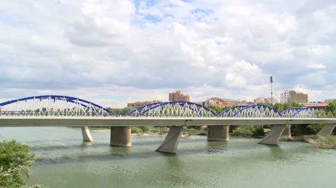 Time lapse on clouds and iron bridge over river Ebro - traffic Stock Footage 38699204