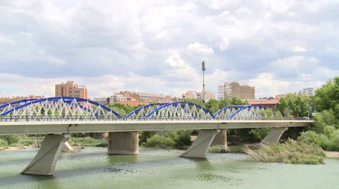 Time lapse on clouds and iron bridge ) over river Ebro , traffic  Stock Footage 38699815