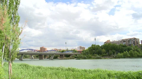 Time lapse on clouds and iron bridge over river Ebro Stock Footage 38703603