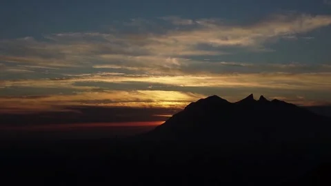 Time lapse of Clouds and Mountain Silhouette during Sunrise Video stock 263383154