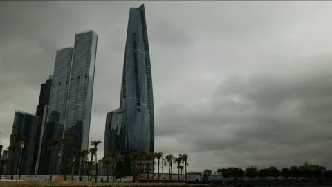 Time lapse clouds and pedestrians pass Sydney Crown Casino 4K Stock Footage 302058072