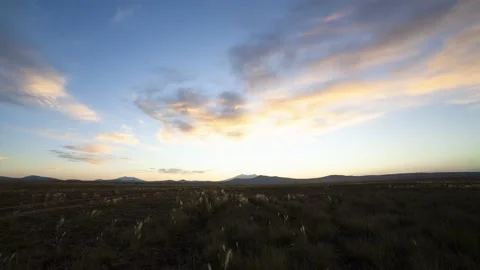 Time lapse of clouds and the rising sun on a vast prairie Stock Footage 135737189