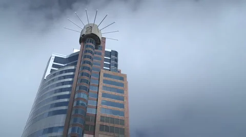 Time lapse of clouds and a stylish office tower Stock Footage 1038848