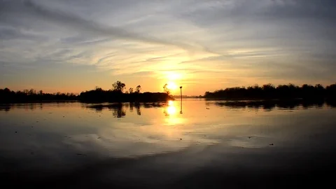 Time Lapse of Clouds and Sun on River Stock Footage 73780633